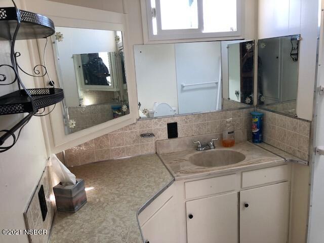 1095 West McCoy Lane, Unit 16 Santa Maria, CA 93455 - Photo 11 of 16 a bathroom with a sink and a mirror