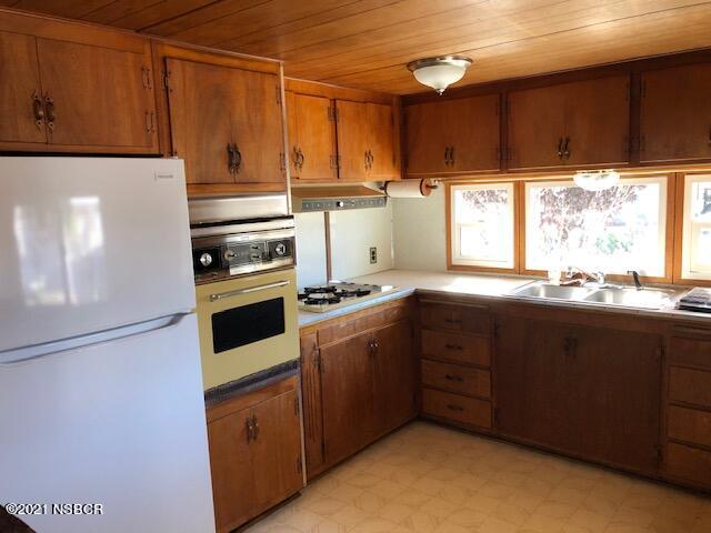 1095 West McCoy Lane, Unit 16 Santa Maria, CA 93455 - Photo 3 of 16 a kitchen with a sink window and cabinets