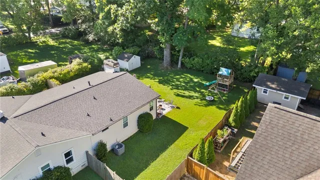 an aerial view of a house with a yard pool patio and outdoor seating