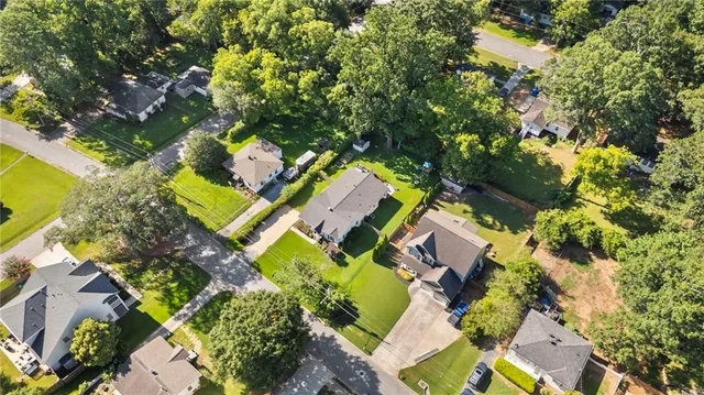 an aerial view of residential house with outdoor space and trees all around