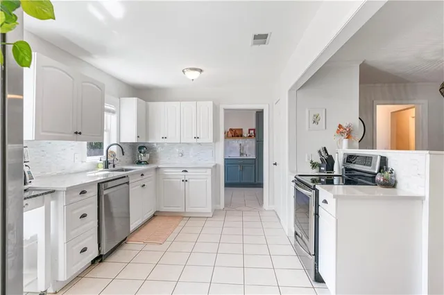 a kitchen with a stove sink and cabinets