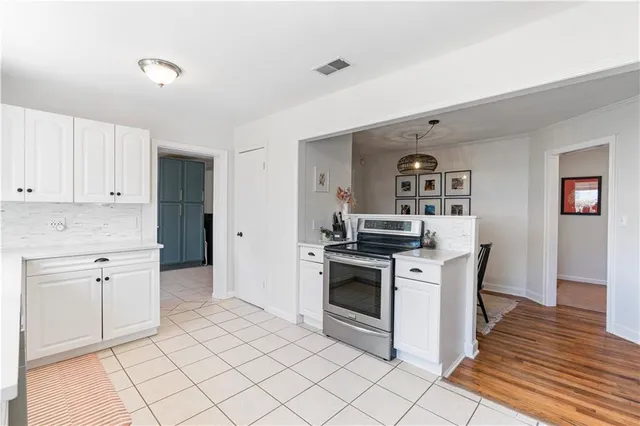 a kitchen with granite countertop white cabinets and white appliances
