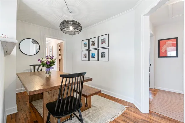 a view of a dining room with furniture wooden floor and a chandelier