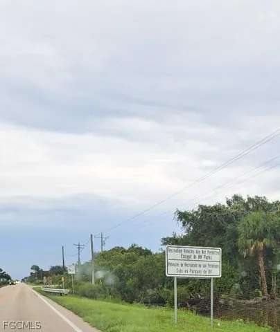a view of a lake with couches chairs