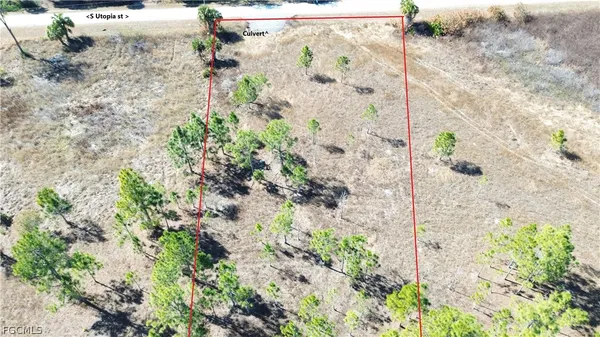 a view of mirror with bathtub in background