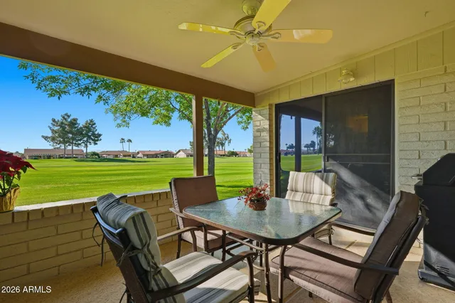 a view of an outdoor dining space with a table and chairs