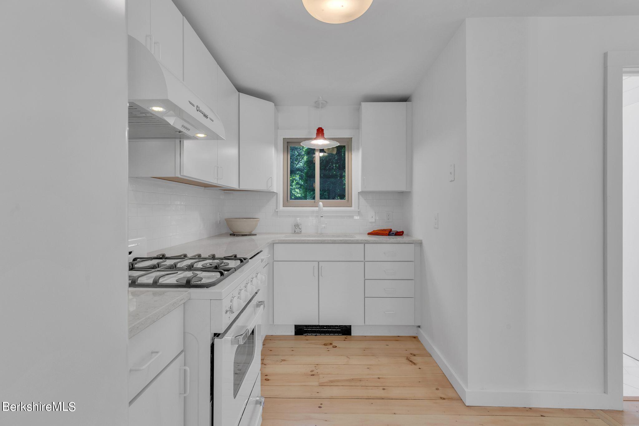 21 Sandisfield Road Sandisfield, MA 01255 - Photo 25 of 65 a kitchen with white cabinets and window
