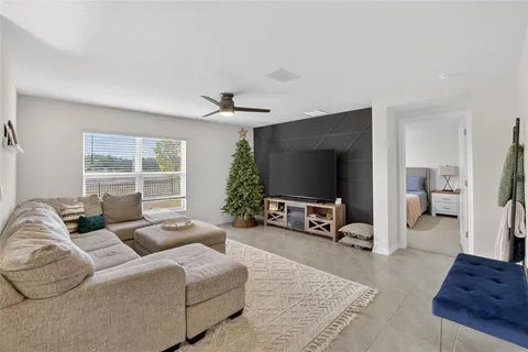 a living room with furniture a window and a flat screen tv