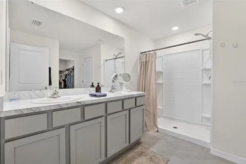 a bathroom with a shower and a sink