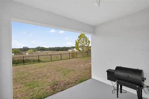 a view of a house with backyard and porch