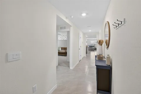 a large white kitchen with stainless steel appliances granite countertop a stove a sink a refrigerator and white cabinets