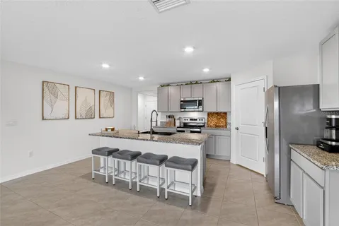 a kitchen with stainless steel appliances a refrigerator and a stove top oven