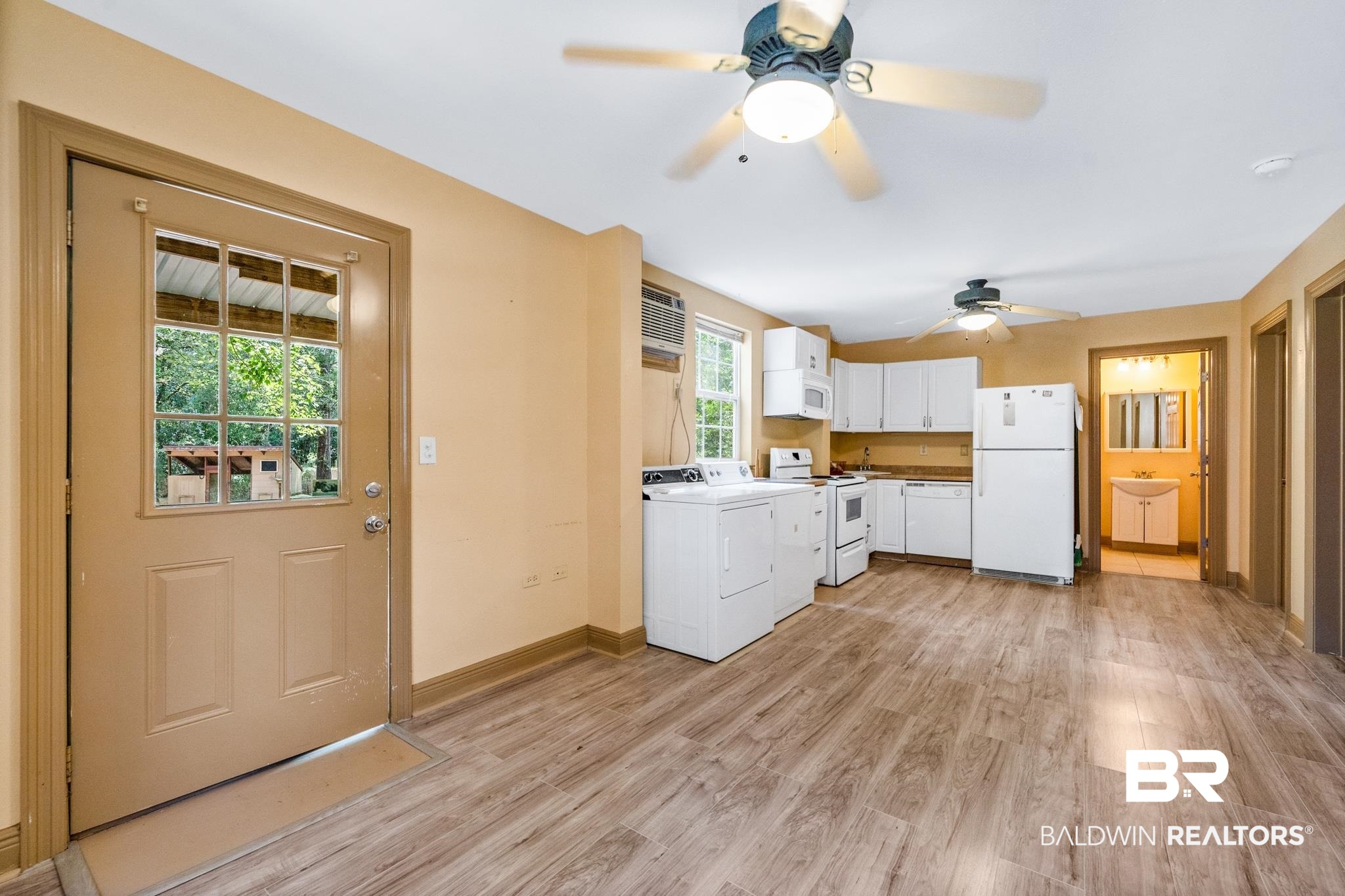 8321 Dixon Road Bay Minette, AL 36507 - Photo 58 of 79 Kitchen Apartment featuring washer and dryer, ceiling fan, white cabinets, light wood-type flooring, and white appliances