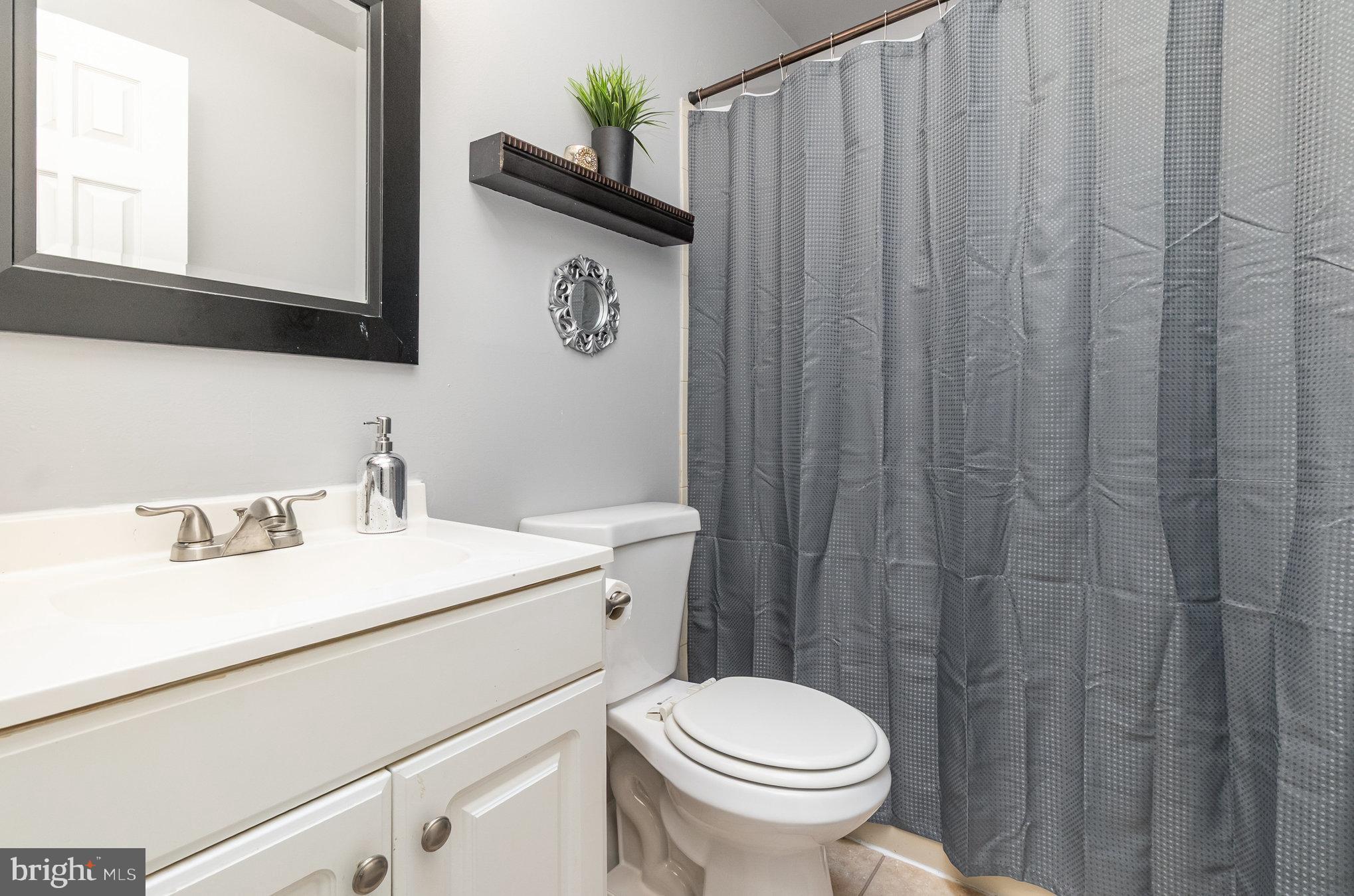 22 Bryce Court Baltimore, MD 21236 - Photo 16 of 28 a bathroom with a toilet sink vanity and mirror