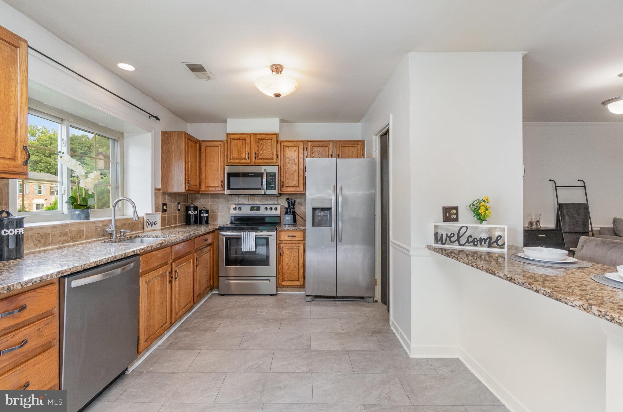 22 Bryce Court Baltimore, MD 21236 - Photo 6 of 28 a large kitchen with stainless steel appliances granite countertop a refrigerator and a sink