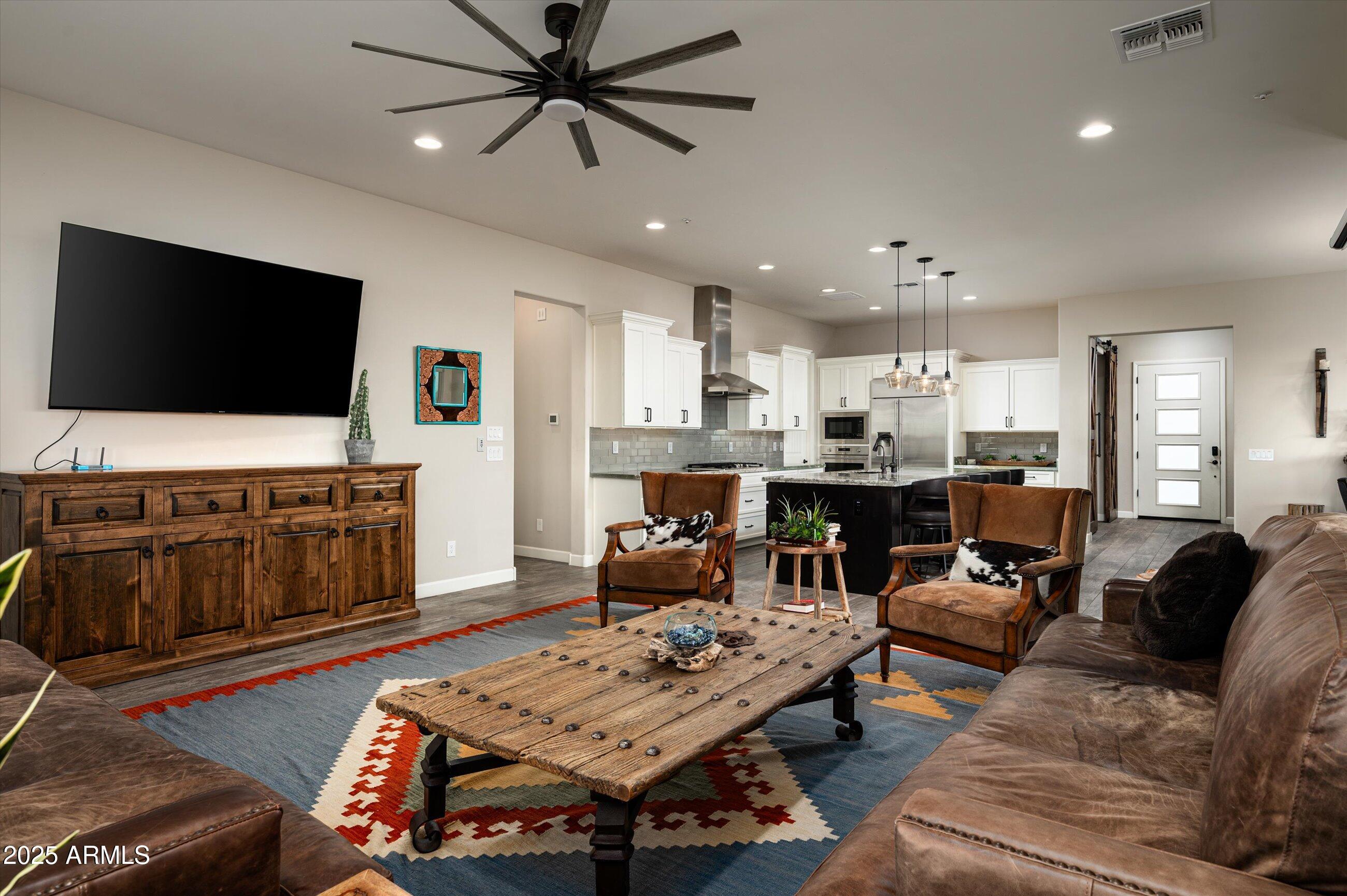 17971 East Cindercone Road Rio Verde, AZ 85263 - Photo 12 of 58 a living room with furniture and a flat screen tv
