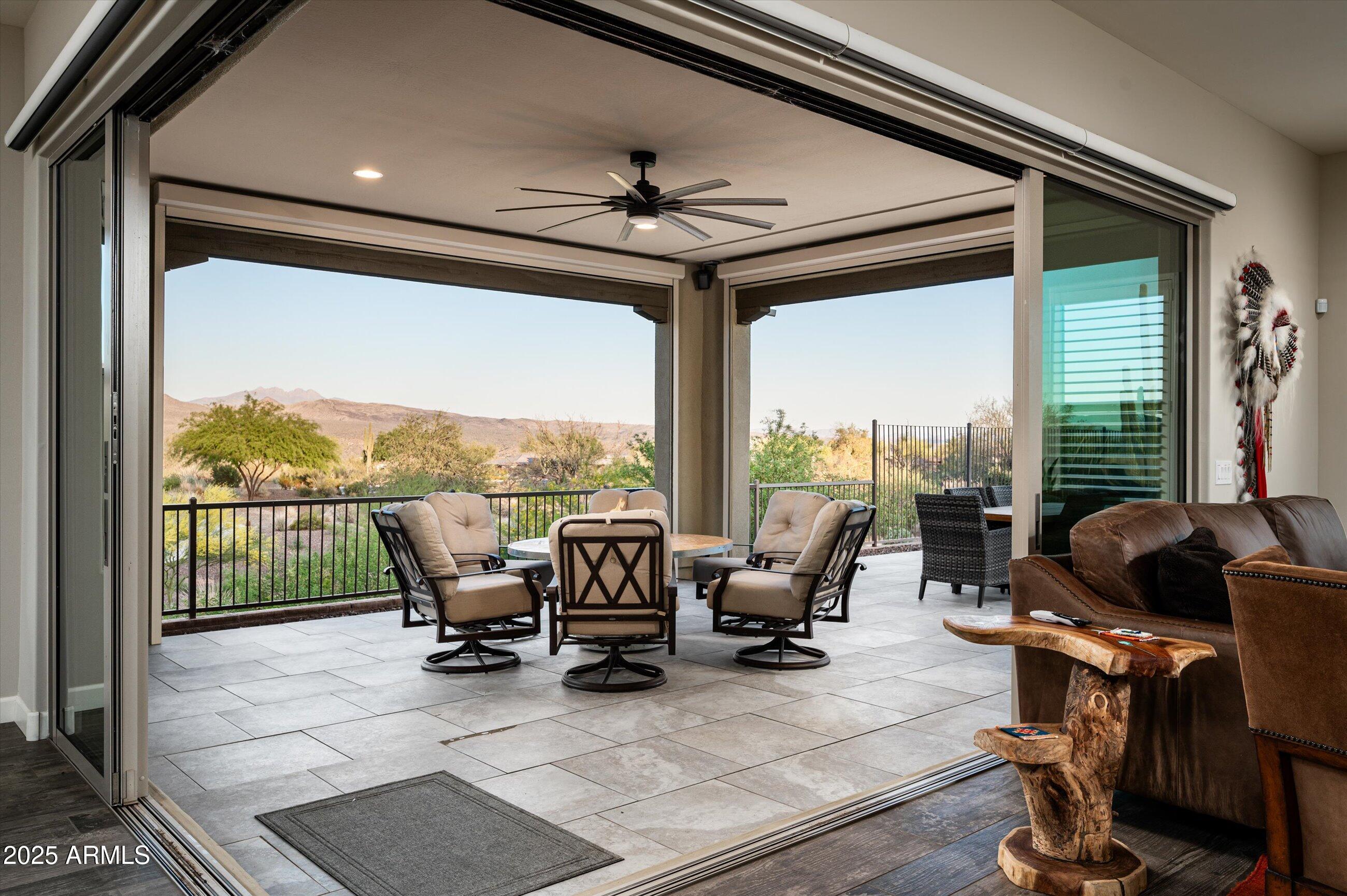17971 East Cindercone Road Rio Verde, AZ 85263 - Photo 14 of 58 a living room with furniture floor to ceiling windows and a ceiling fan