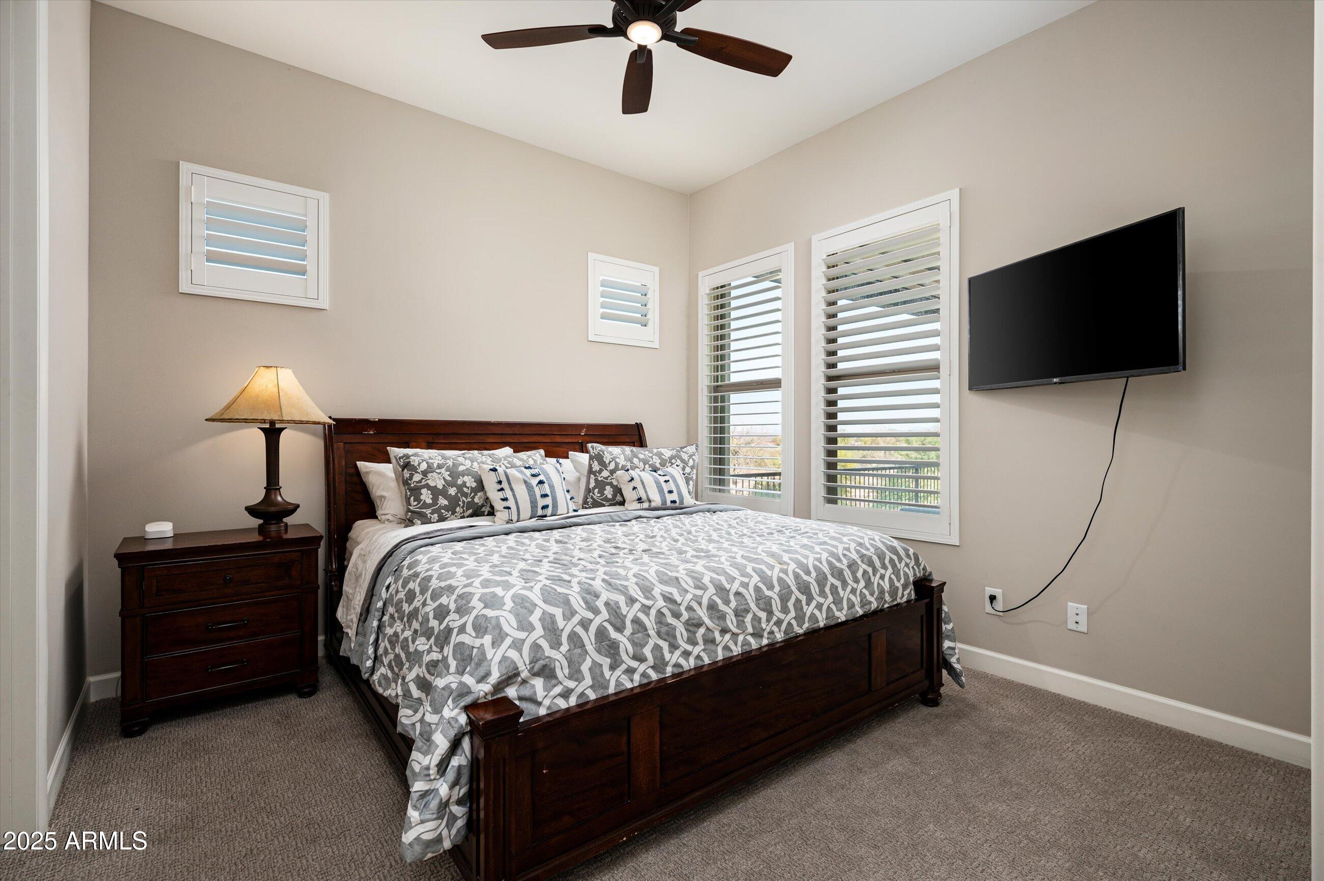 17971 East Cindercone Road Rio Verde, AZ 85263 - Photo 24 of 58 a bed sitting in a bedroom and a flat screen tv