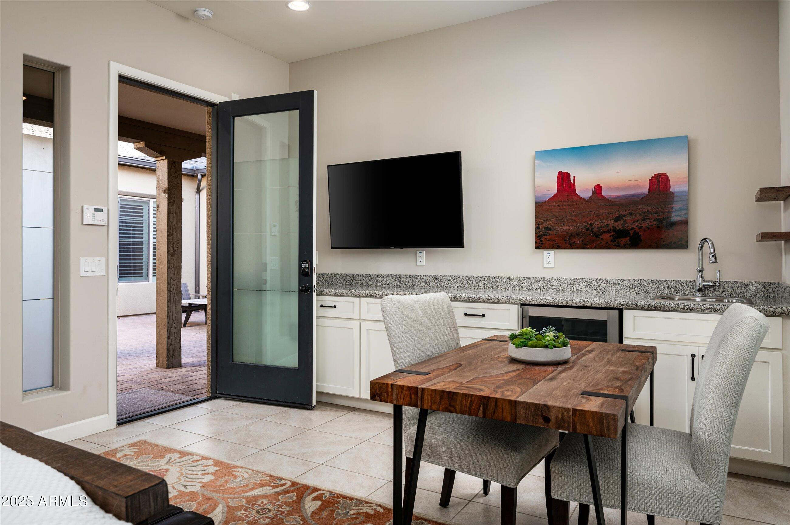 17971 East Cindercone Road Rio Verde, AZ 85263 - Photo 29 of 58 a view of a dining room with furniture and a flat screen tv