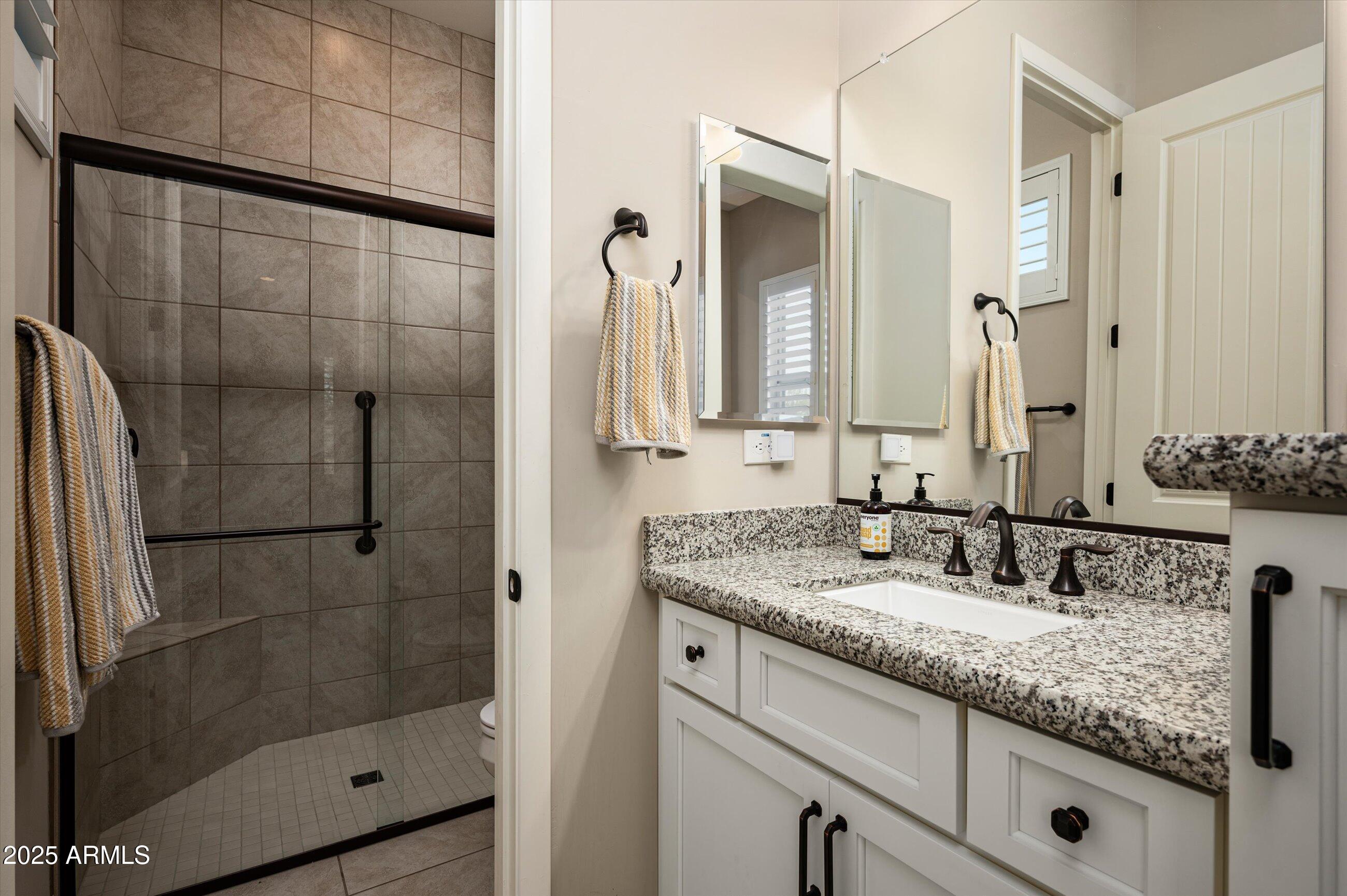17971 East Cindercone Road Rio Verde, AZ 85263 - Photo 31 of 58 a bathroom with a granite countertop sink and a mirror