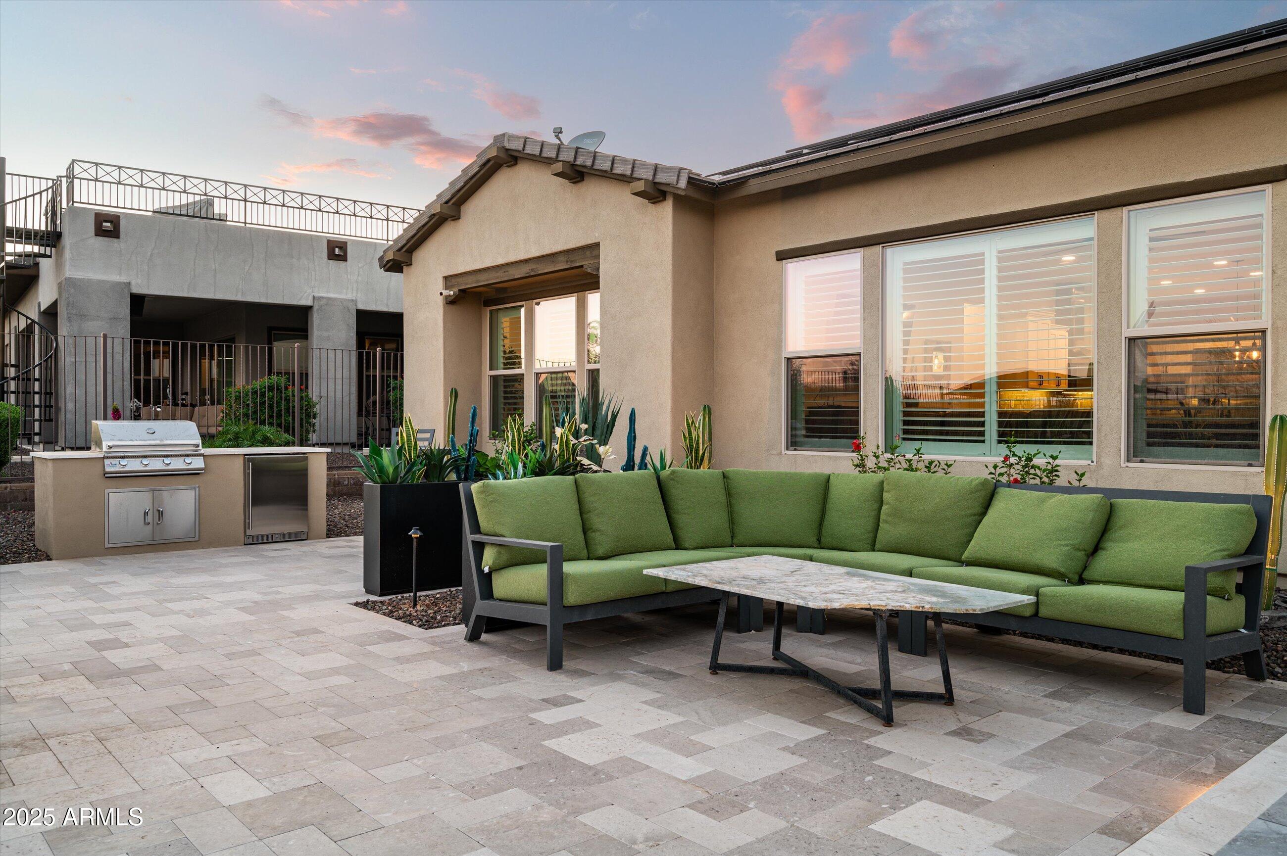 17971 East Cindercone Road Rio Verde, AZ 85263 - Photo 34 of 58 a view of a patio with couches chairs and a potted plant