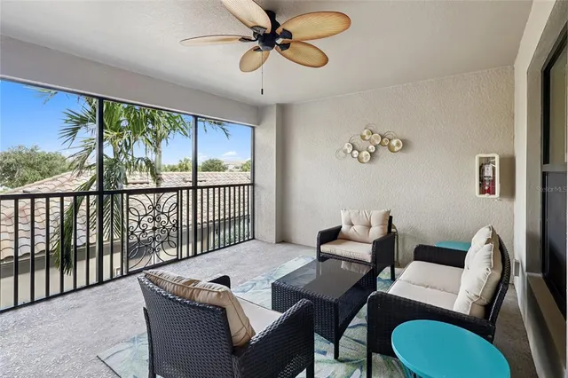 a view of a livingroom and a dining room with furniture window and outside view
