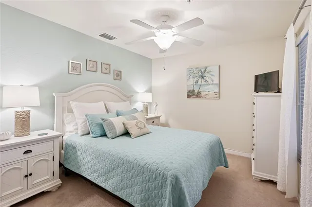 a bedroom with a bed and a night stand