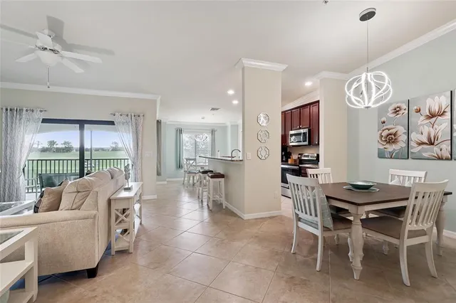 a living room with furniture a large window and a table