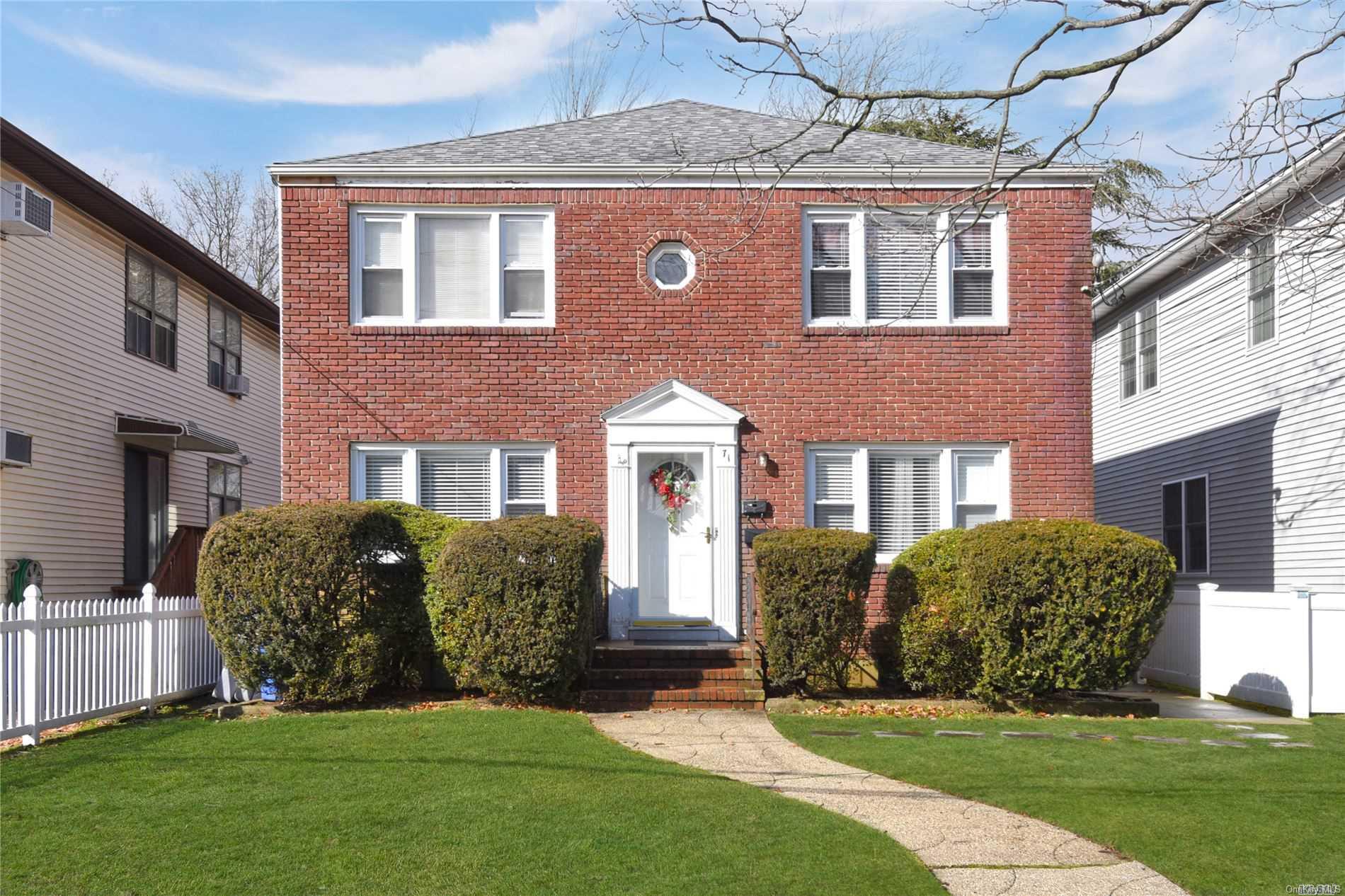 71 Evergreen Avenue Lynbrook, NY 11563 - Photo 1 of 1 a front view of a house with a yard