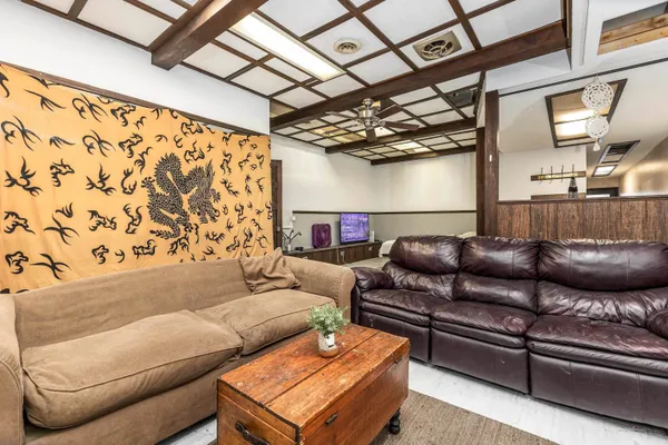a living room with a couch and a chandelier