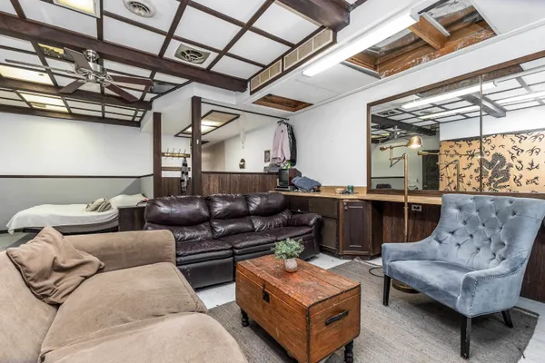 a living room with furniture and a chandelier