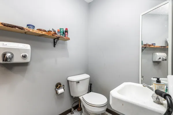 a white toilet sitting next to a bathroom sink