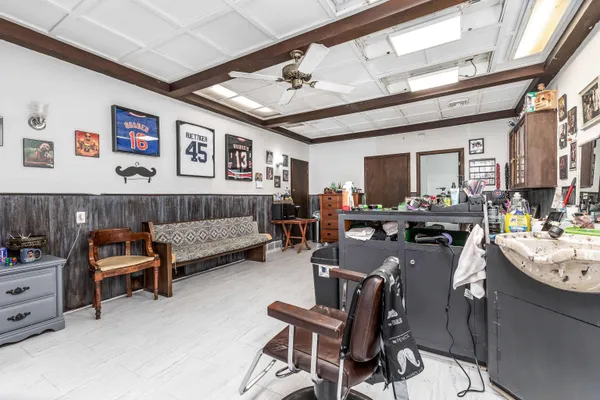 a living room with furniture and paintings on the wall
