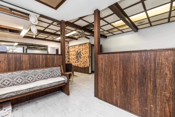 a bed sitting in a room next to a window