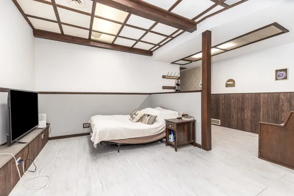 a bedroom with a bed and a flat screen tv