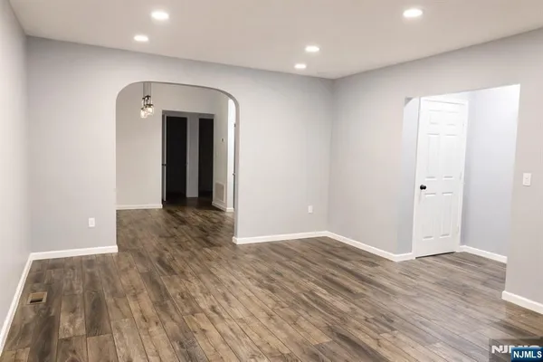a view of livingroom with hallway and wooden floor