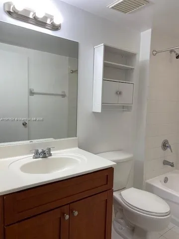 a bathroom with a sink toilet and vanity
