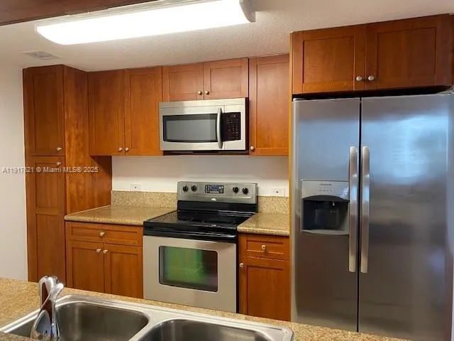a kitchen with a refrigerator stove and microwave