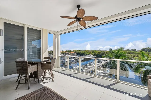 a view of a chairs and table in the balcony