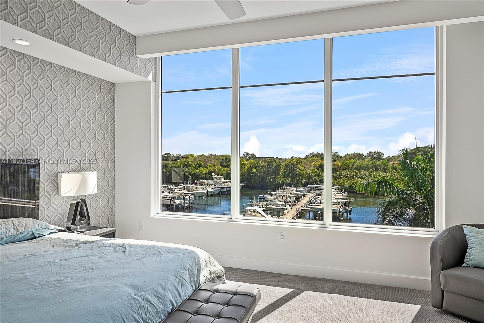 2720 Donald Ross Road, Unit 406 Palm Beach Gardens, FL 33410 - Photo 13 of 35 a bedroom with a large bed and a window