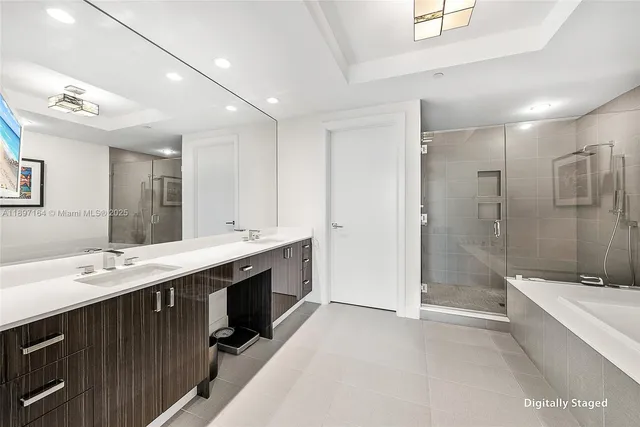 a spacious bathroom with a double vanity sink mirror double and shower