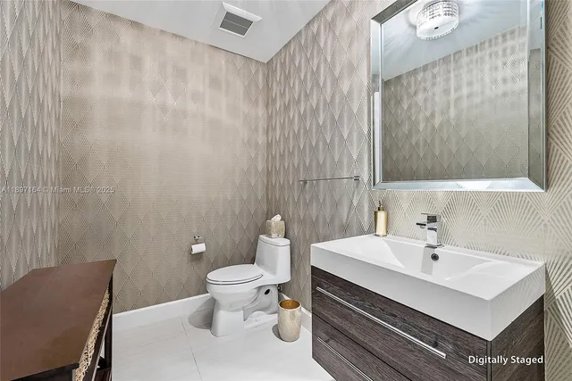 a bathroom with a sink a toilet and a mirror