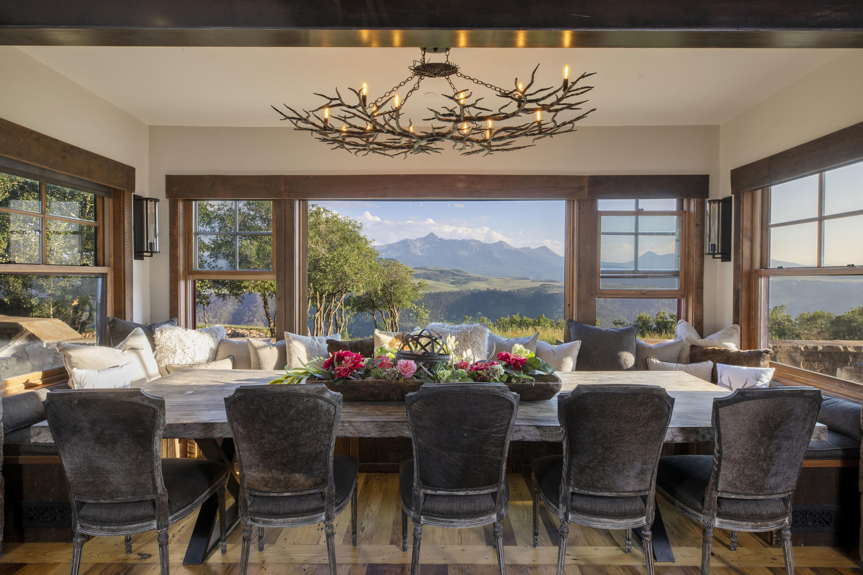 7039 Last Dollar Road Telluride, CO 81435 - Photo 10 of 52 a view of a dining room with furniture large windows and wooden floor