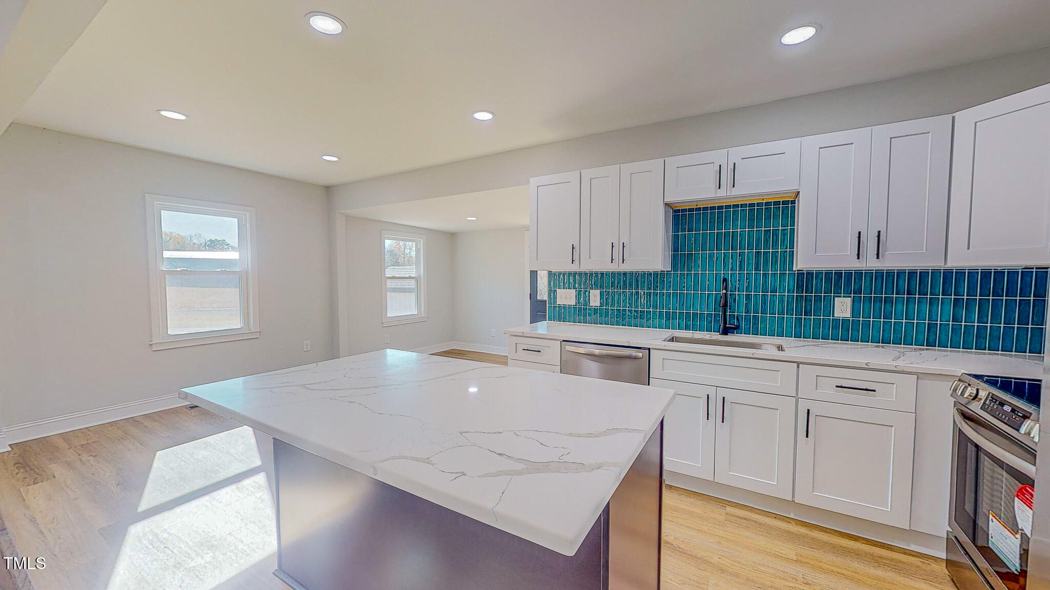 981 Country Club Road Roxboro, NC 27574 - Photo 5 of 45 a kitchen with granite countertop white cabinets and white appliances