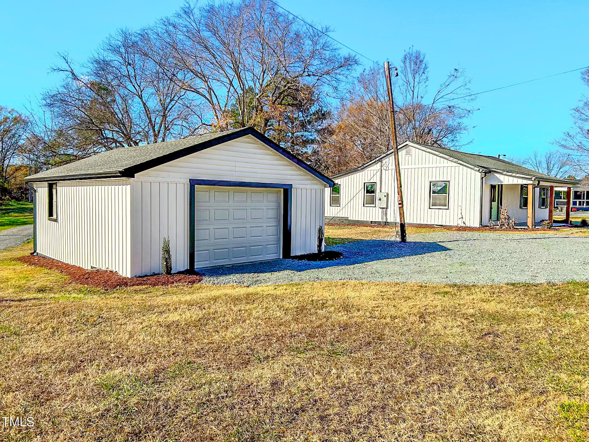 981 Country Club Road Roxboro, NC 27574 - Photo 6 of 45 a view of a house with a yard and garage
