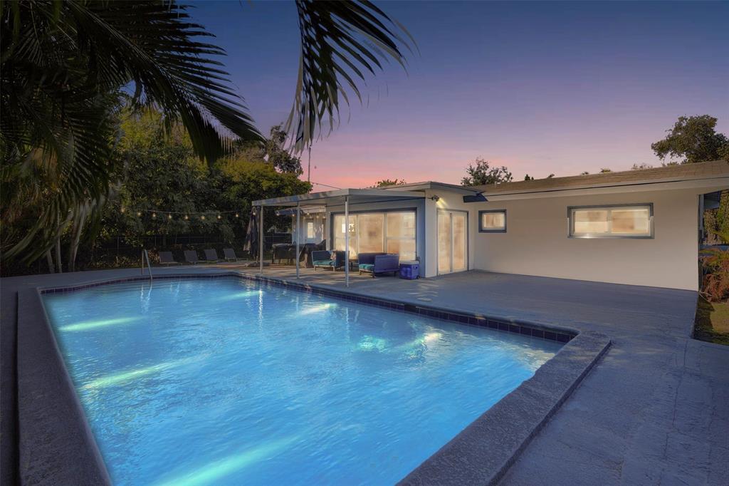 1050 Northeast 150th Street Miami, FL 33161 - Photo 1 of 50 a view of a house with pool and sitting area