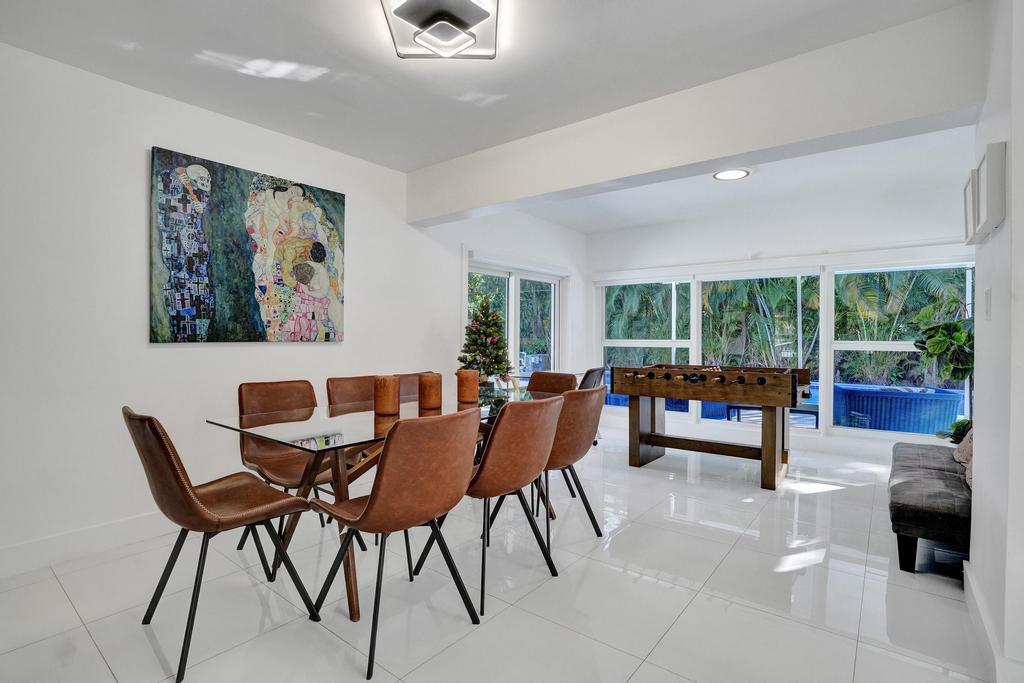 1050 Northeast 150th Street Miami, FL 33161 - Photo 13 of 50 a dining room with furniture and a large window
