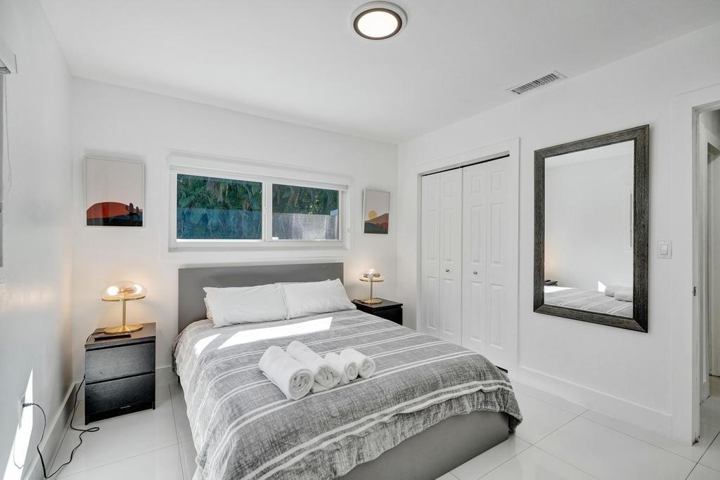 1050 Northeast 150th Street Miami, FL 33161 - Photo 20 of 50 a bedroom with a bed and window