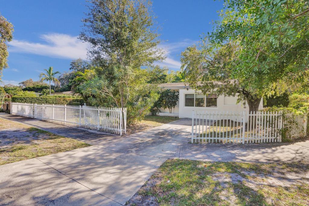 1050 Northeast 150th Street Miami, FL 33161 - Photo 2 of 50 a view of a house with a fence