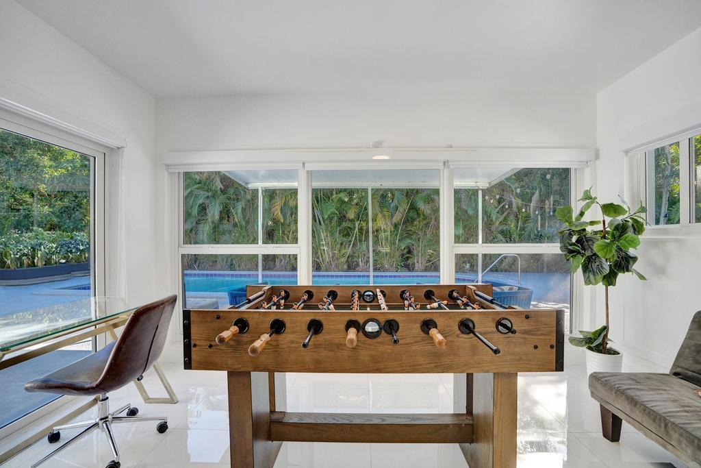 1050 Northeast 150th Street Miami, FL 33161 - Photo 23 of 50 a bed sitting in a bedroom next to a window